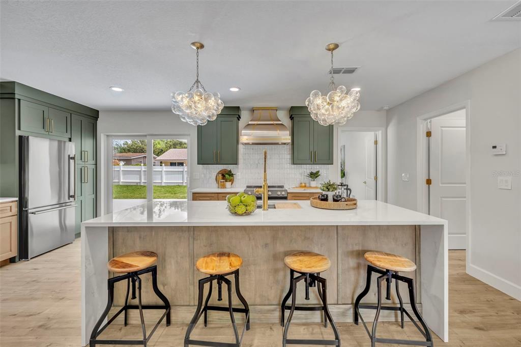 350 Cornwall Road Winter Park, FL 32792 - Photo 11 of 36 a kitchen with stainless steel appliances a dining table chairs and chandelier
