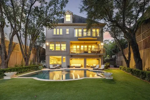 a view of pool with brick walls and floor to ceiling window