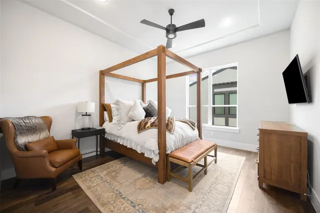 a living room with furniture a flat screen tv and a window