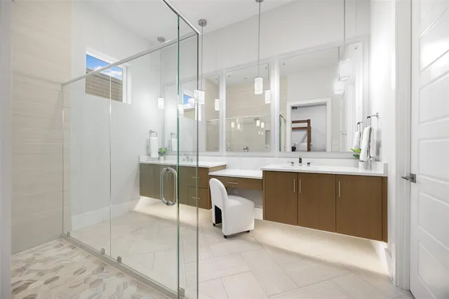 a bathroom with a double vanity sink mirror and bathtub