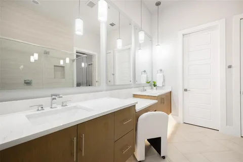 a bathroom with a sink double vanity and a mirror