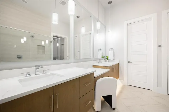 a bathroom with a sink double vanity and a mirror