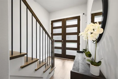 a view of entryway and hall with wooden floor
