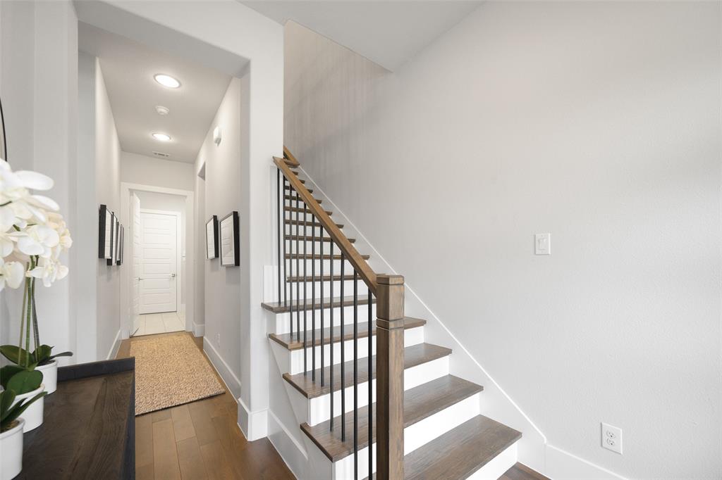 7632 Highcroft Way Plano, TX 75024 - Photo 20 of 28 a view of a hallway with wooden floor and staircase