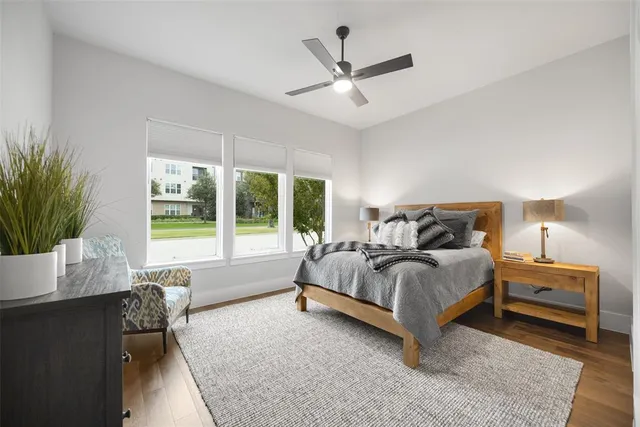 a spacious bedroom with a bed and a window