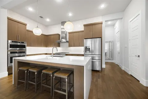 a kitchen with kitchen island a sink appliances and cabinets