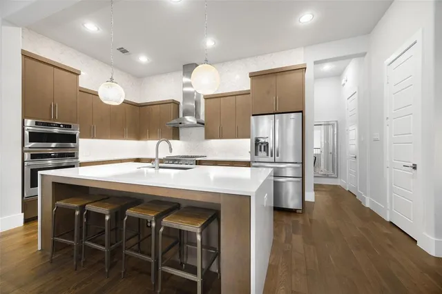 a kitchen with kitchen island a sink appliances and cabinets