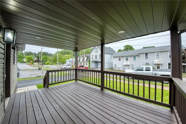 a view of a balcony with wooden floor