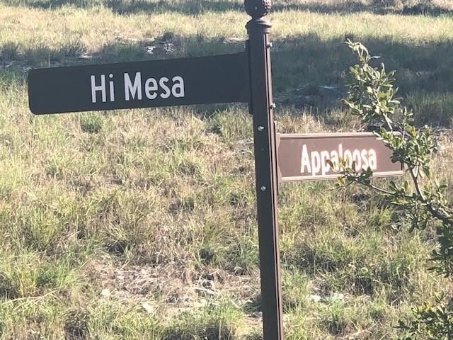 a street sign that is sitting in front of a house
