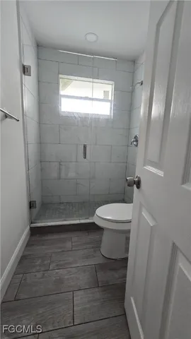 a bathroom with a toilet a sink and shower