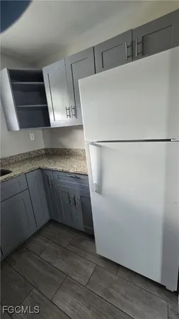 a view of a refrigerator a sink and dishwasher