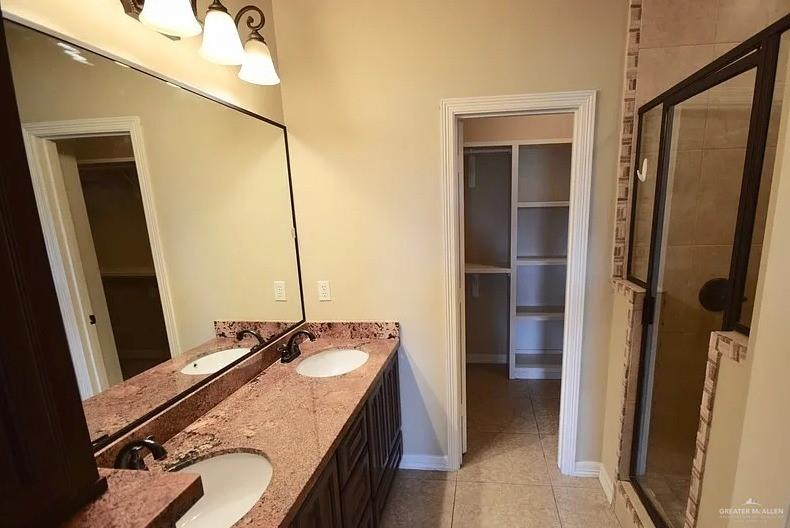 1919 West Ventura Drive Pharr, TX 78577 - Photo 10 of 20 Full bath featuring a walk in closet, a shower stall, double vanity, and light tile patterned floors