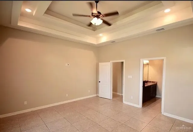a bathroom with a granite countertop toilet a sink and a mirror