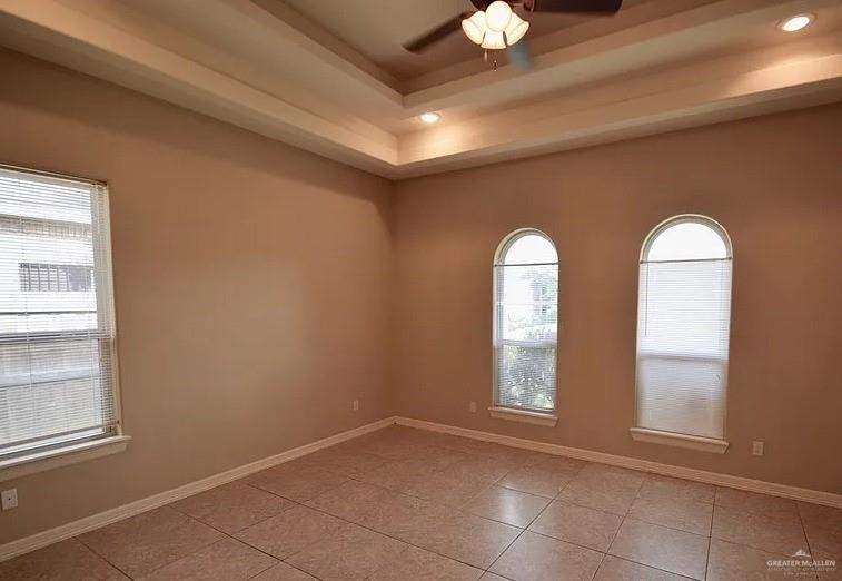 1919 West Ventura Drive Pharr, TX 78577 - Photo 15 of 20 Empty room with a tray ceiling, ceiling fan, recessed lighting, and light tile patterned floors