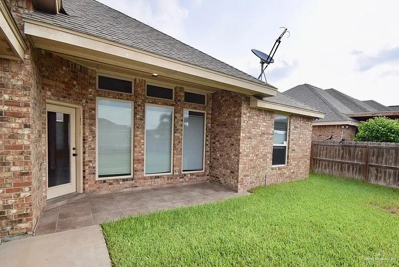 1919 West Ventura Drive Pharr, TX 78577 - Photo 17 of 20 Back of house with a patio, brick siding, and a shingled roof