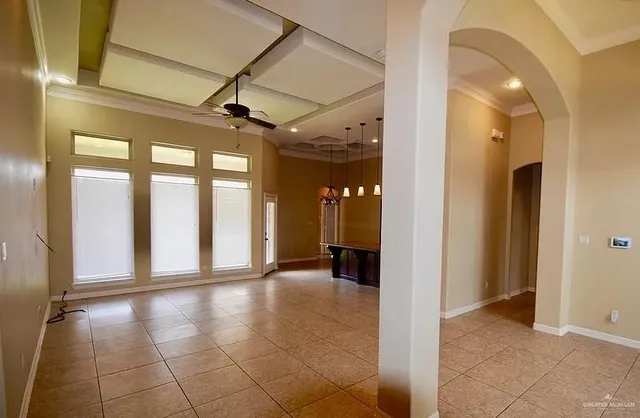 a large kitchen with a large counter top stainless steel appliances and cabinets