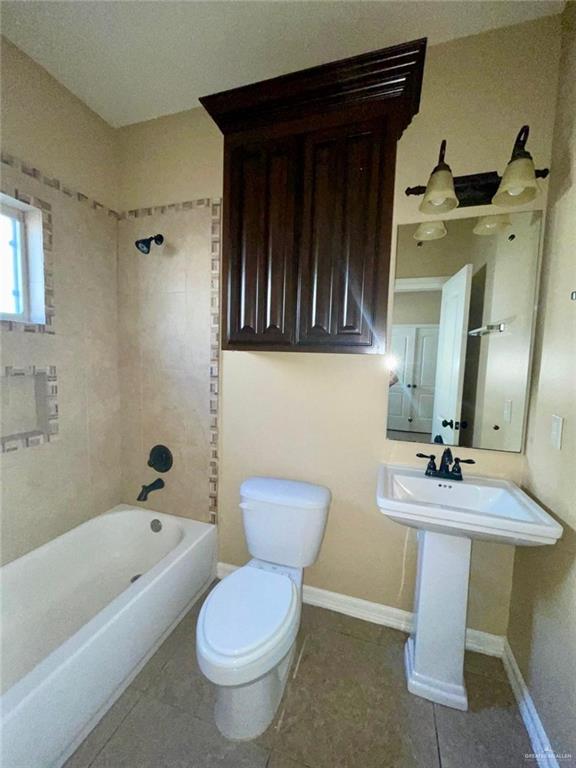 1919 West Ventura Drive Pharr, TX 78577 - Photo 7 of 20 Full bathroom with bathtub / shower combination and dark tile patterned flooring