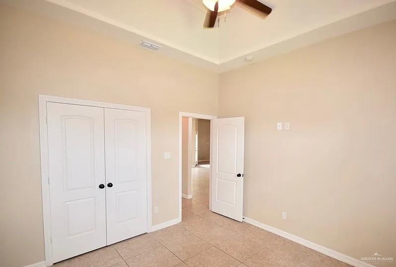 1919 West Ventura Drive Pharr, TX 78577 - Photo 8 of 20 Unfurnished bedroom with light tile patterned floors, a closet, ceiling fan, and a high ceiling