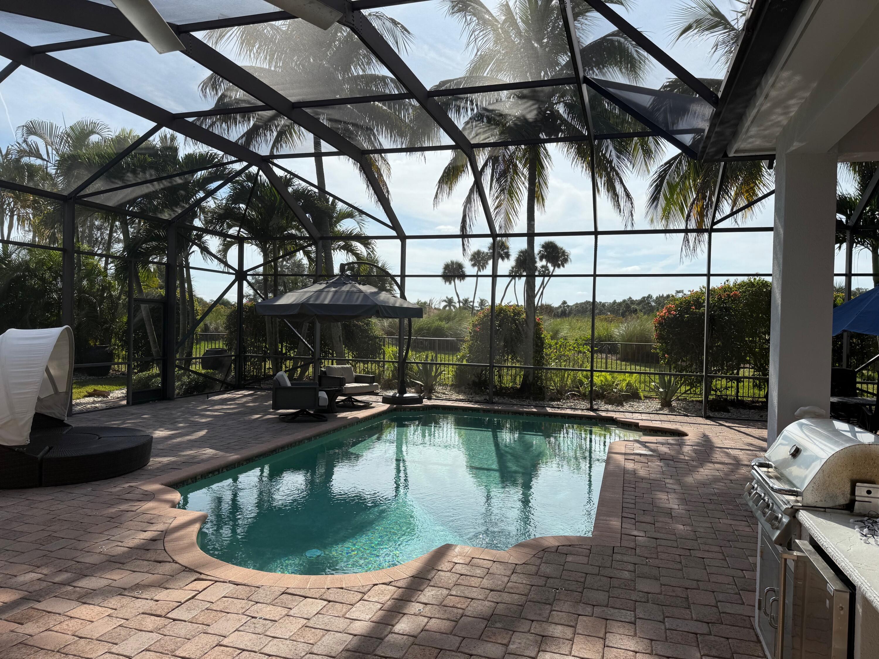 182 Rosalia Court Jupiter, FL 33478 - Photo 13 of 32 a view of a swimming pool with a patio