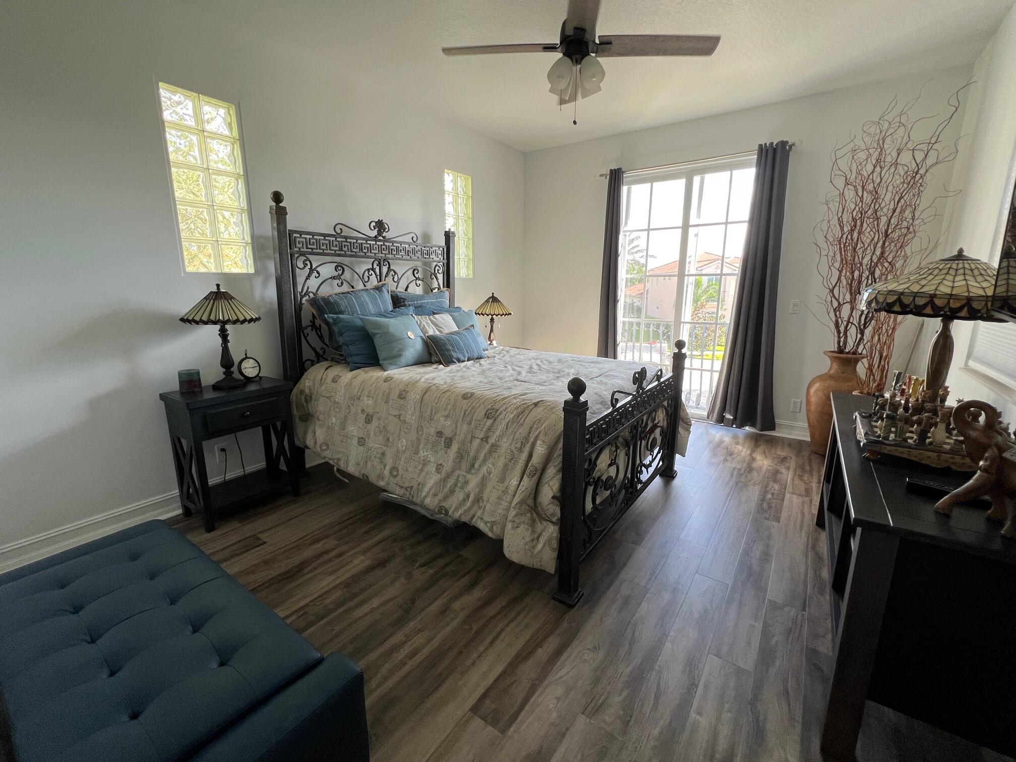 182 Rosalia Court Jupiter, FL 33478 - Photo 19 of 29 a bedroom with a bed and wooden floor