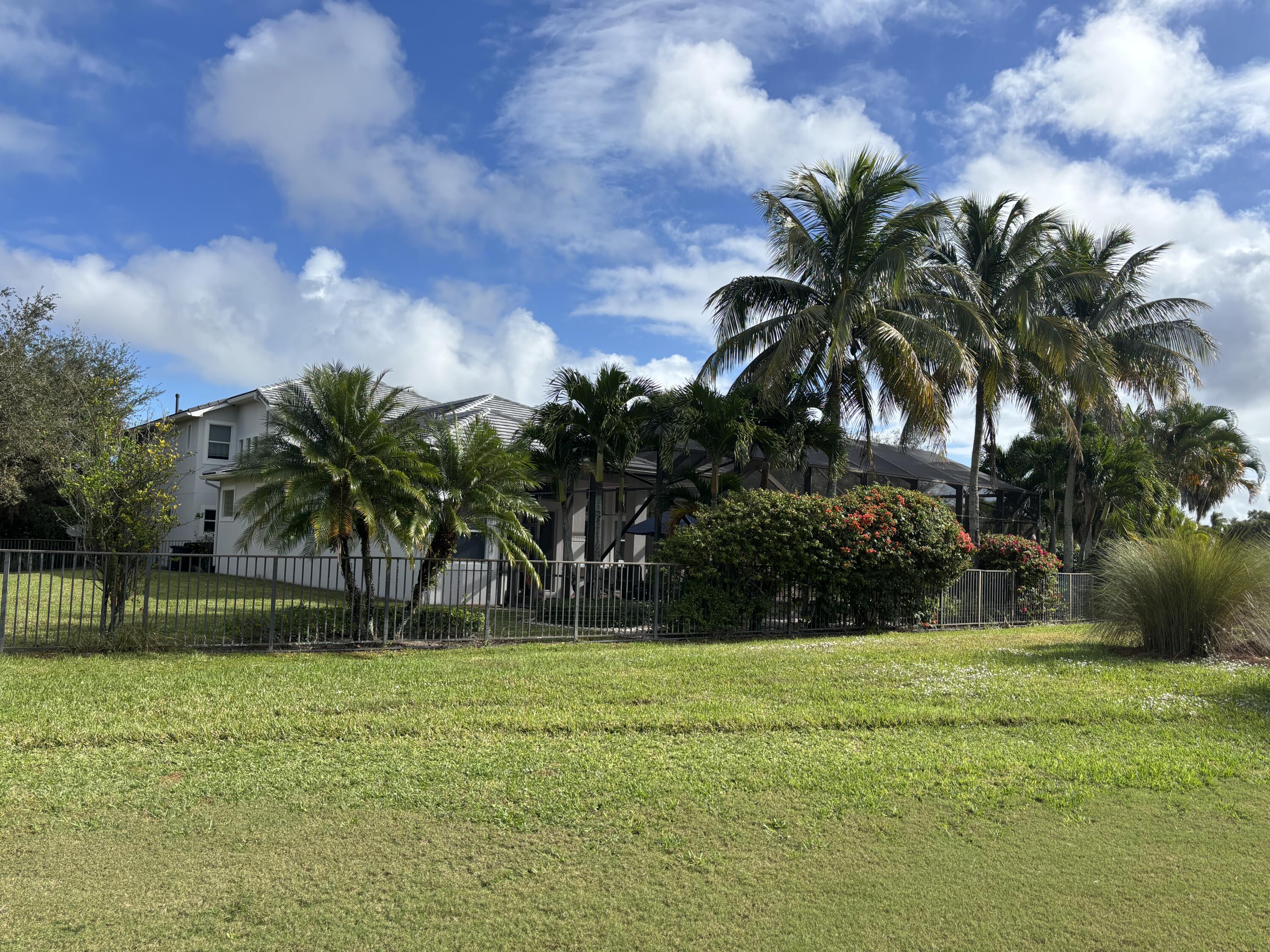 182 Rosalia Court Jupiter, FL 33478 - Photo 28 of 29 a view of a yard and a palm tree