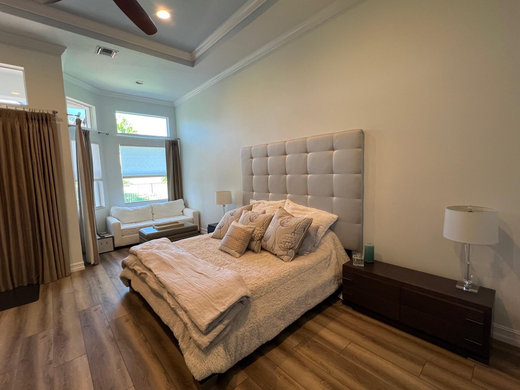 182 Rosalia Court Jupiter, FL 33478 - Photo 6 of 32 a bedroom with a bed and window