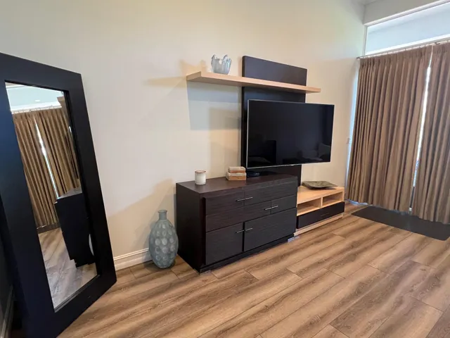 a bathroom with a tub a sink and a mirror
