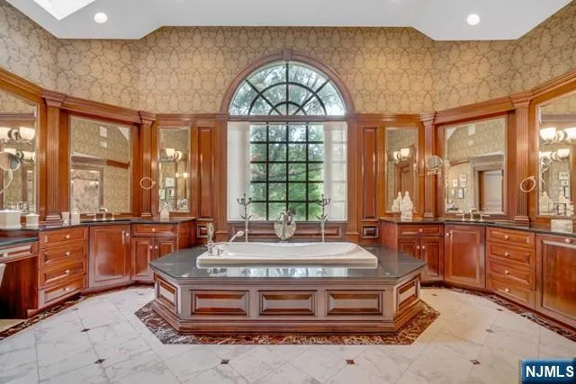 a front view of a house with a yard and trees