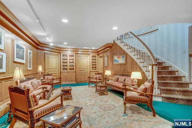 1055 High Mountain Road Franklin Lakes, NJ 07417 - Photo 23 of 42 a living room with furniture ceiling fan and a rug