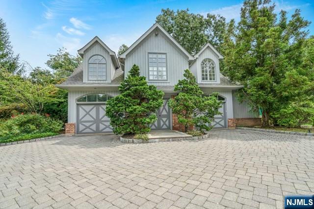 1055 High Mountain Road Franklin Lakes, NJ 07417 - Photo 25 of 42 a front view of a house with a yard and trees