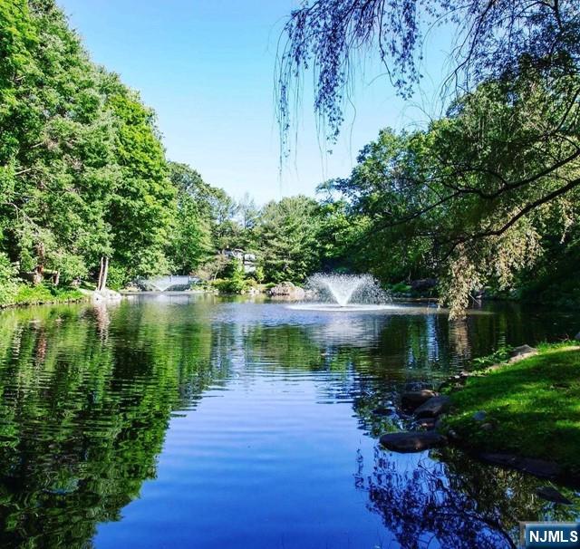 1055 High Mountain Road Franklin Lakes, NJ 07417 - Photo 3 of 42 a view of a lake with a garden