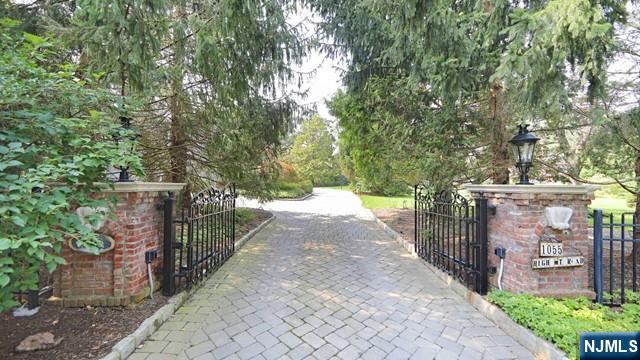 1055 High Mountain Road Franklin Lakes, NJ 07417 - Photo 36 of 42 a view of a pathway of a building with a yard