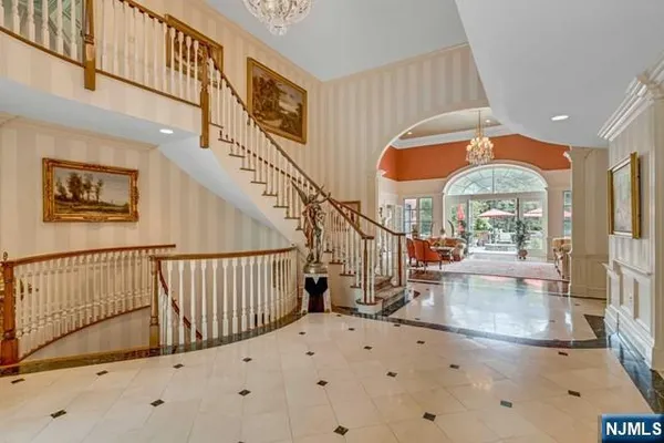 a living room with furniture a fireplace and a chandelier
