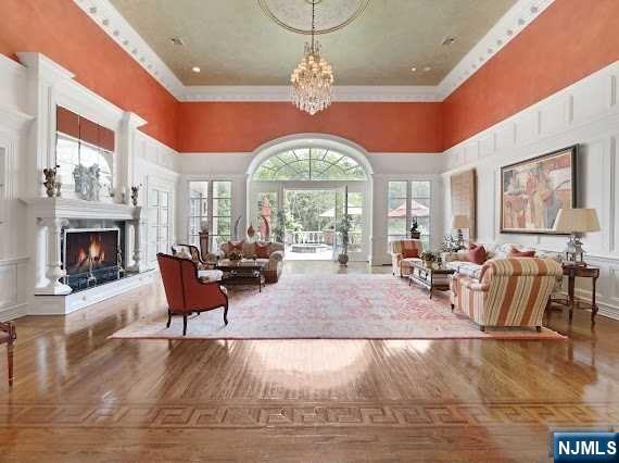 1055 High Mountain Road Franklin Lakes, NJ 07417 - Photo 9 of 42 a living room with furniture a fireplace and a chandelier