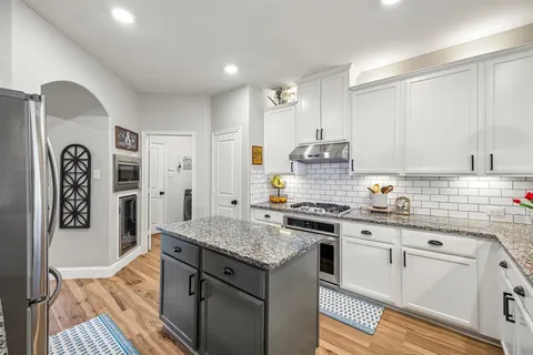 a kitchen with stainless steel appliances granite countertop a stove and a sink