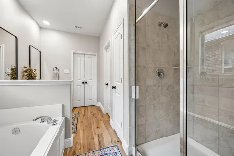 a bathroom with a tub and a shower