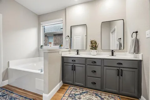 a bathroom with a double vanity sink and mirror
