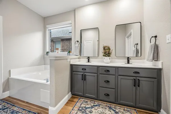 a bathroom with a double vanity sink and mirror