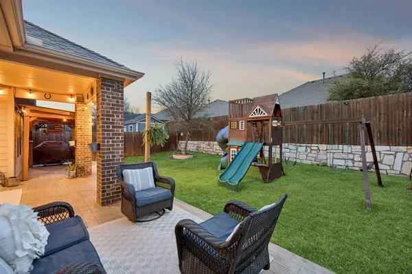 a view of a backyard with furniture and a slide