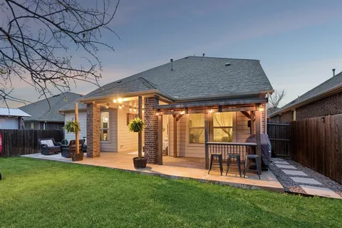 a view of a porch with furniture and a yard