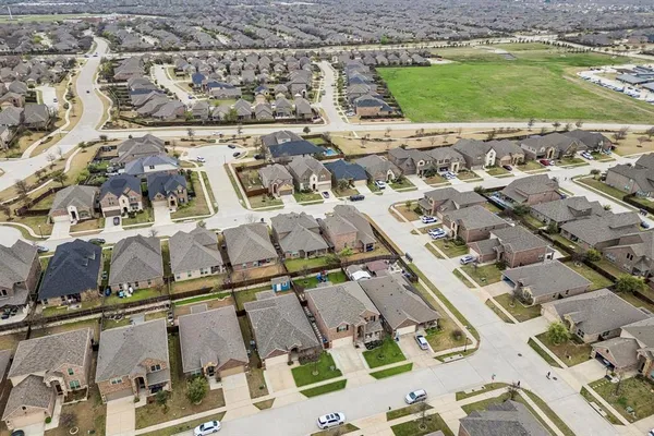 an aerial view of residential houses with outdoor space