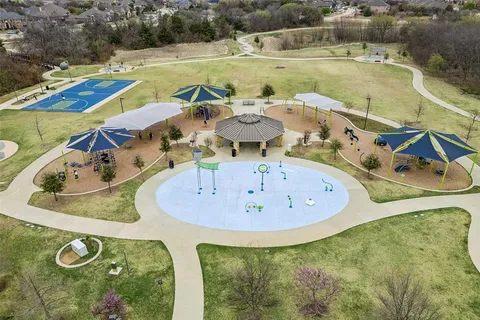 a view of a swimming pool with a yard