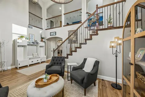 a living room with lots of furniture and stairs