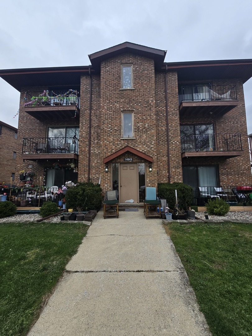 14643 Lamon Avenue, Unit 2B Midlothian, IL 60445 - Photo 2 of 2 a front view of a house with a yard and garage