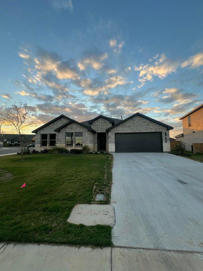 10518 Aberdeen Avenue Lubbock, TX 79424 - Photo 1 of 20 a front view of a house with a yard