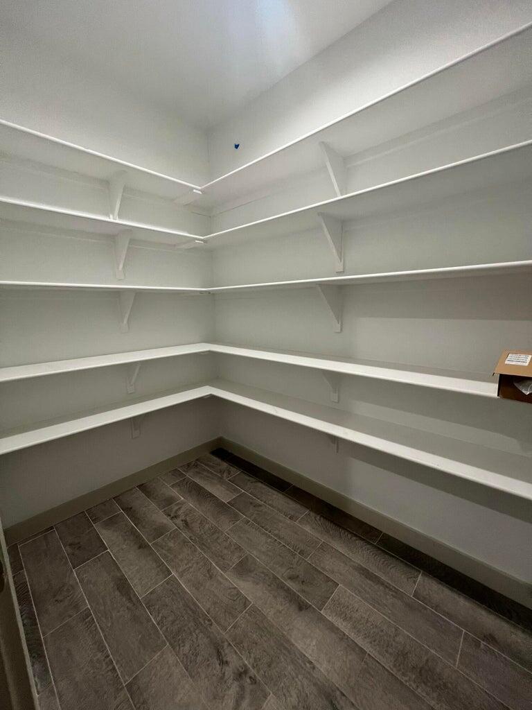 10518 Aberdeen Avenue Lubbock, TX 79424 - Photo 13 of 20 a storage room with a wooden floor