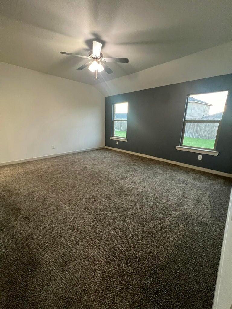 10518 Aberdeen Avenue Lubbock, TX 79424 - Photo 15 of 20 en empty room with windows and fan