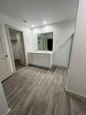 a view of a kitchen with wooden floor and electronic appliances