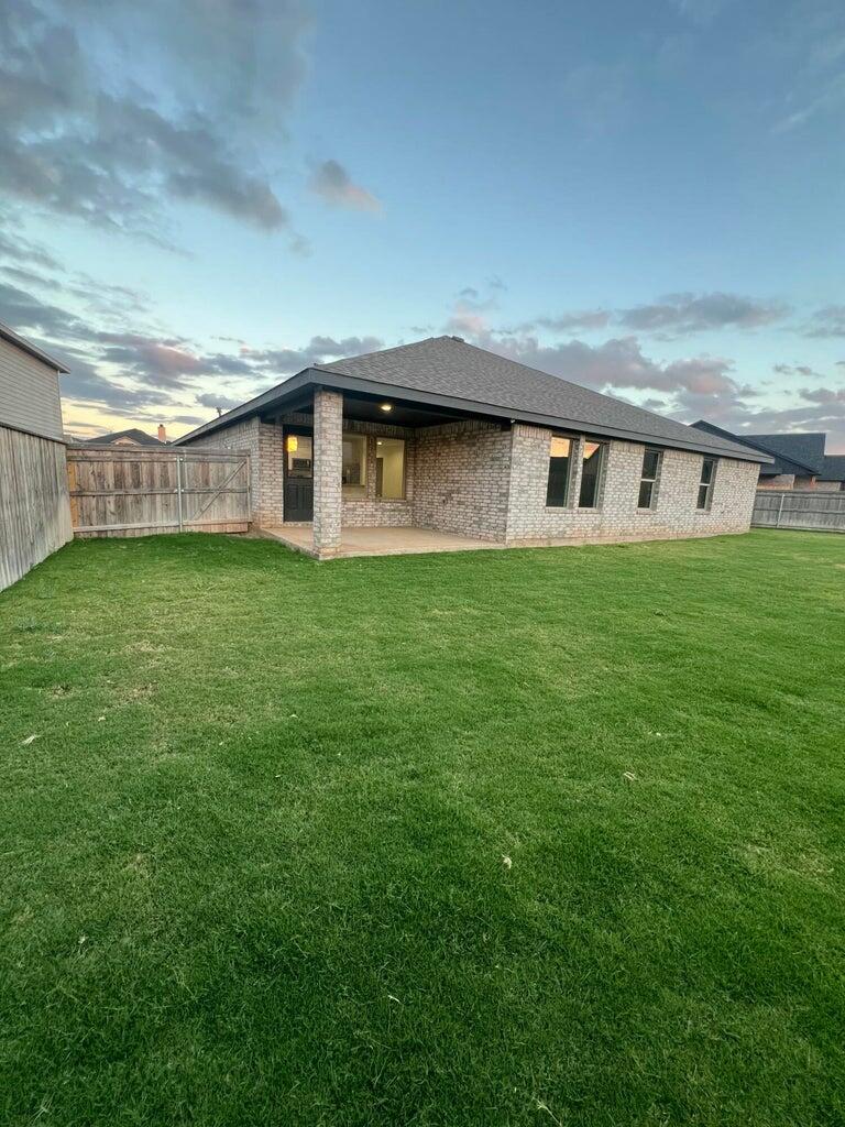 10518 Aberdeen Avenue Lubbock, TX 79424 - Photo 19 of 20 a front view of a house with garden