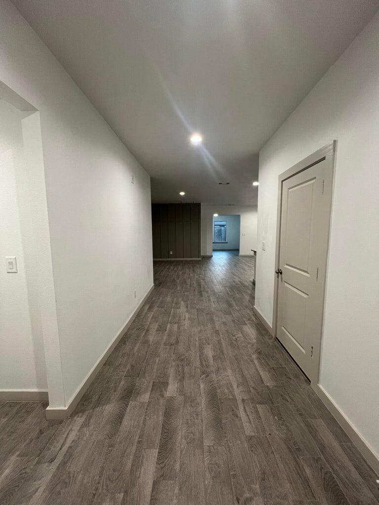 10518 Aberdeen Avenue Lubbock, TX 79424 - Photo 2 of 20 a view of a hallway with wooden floor